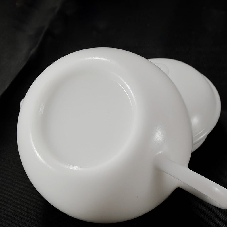 Hand holding collectible mini teapot, highlighting its compact, elegant design.