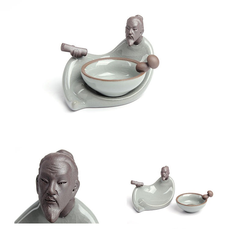 Front view of Ge Kiln tea infuser and holder set on a tea table