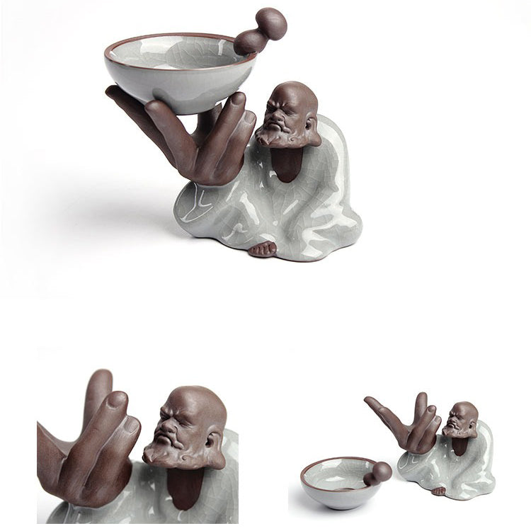 Tea infuser being used to pour brewed loose leaf tea into a cup