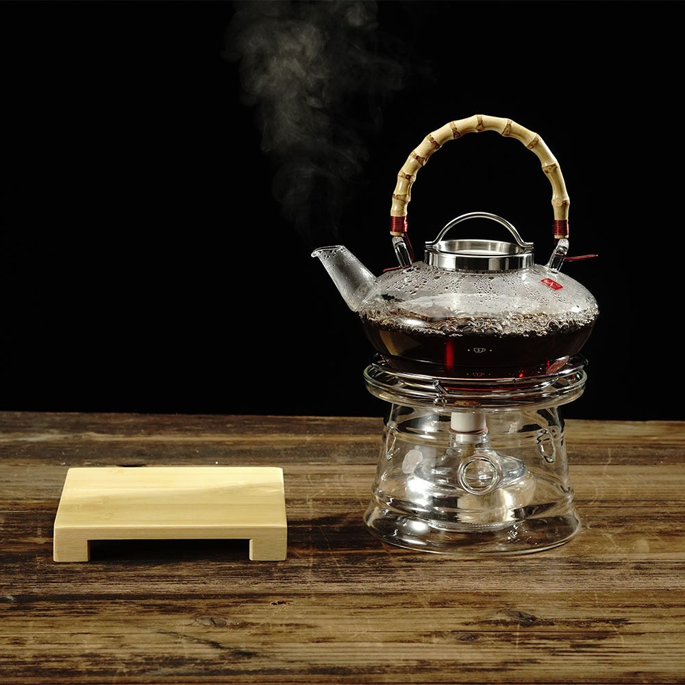 Close-up of glass teapot with alcohol burner in use