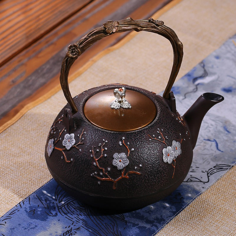 Close-up of the teapots body featuring beautifully carved birds and the unique withered vine texture.