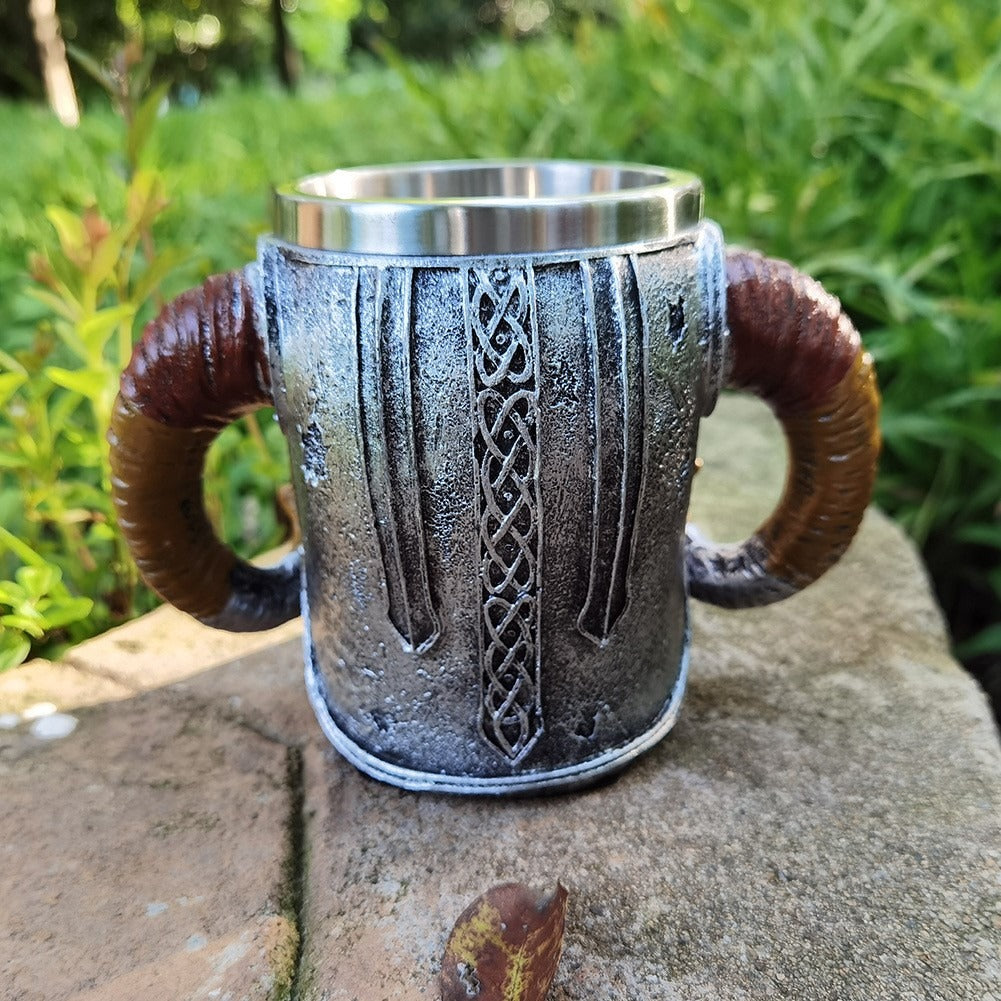 Travel setup featuring the thermal travel mug with skull and helmet motifs