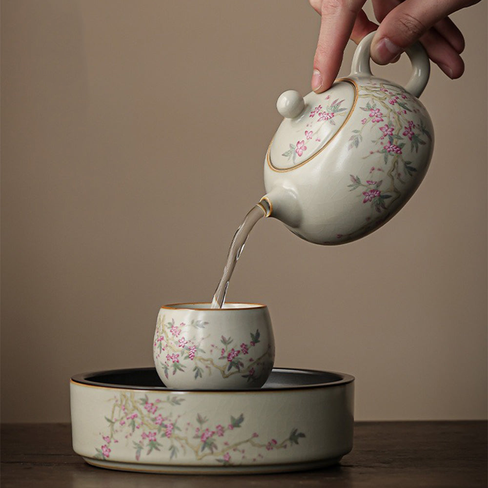 Elegant Peach Blossom Ru Yao Kung Fu Tea Set displayed on a wooden table, highlighting the intricate peach branch pattern.