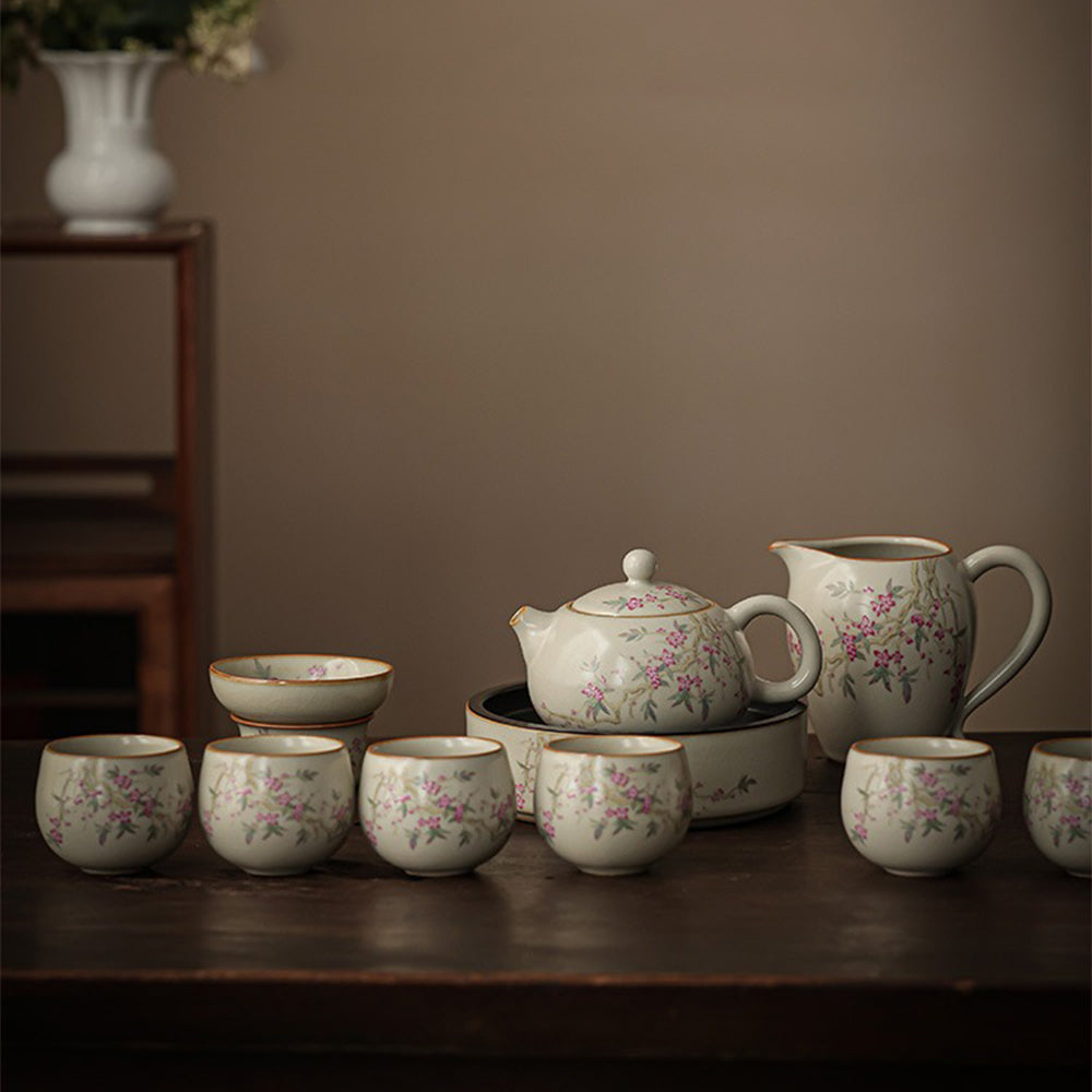 Elegant Peach Blossom Ru Yao Kung Fu Tea Set displayed on a wooden table, highlighting the intricate peach branch pattern.