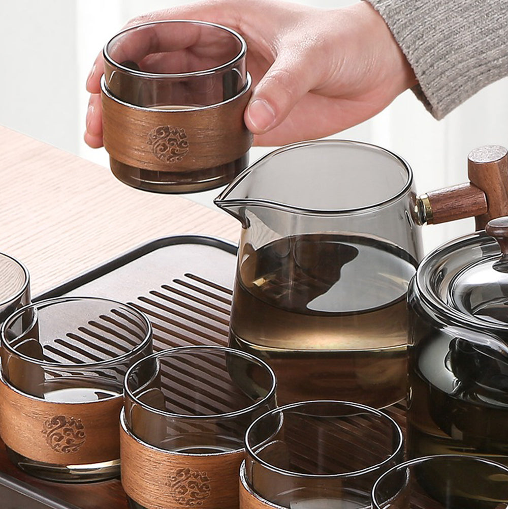 Close-up of the elegant glass teapot with wooden handle and tea cups
