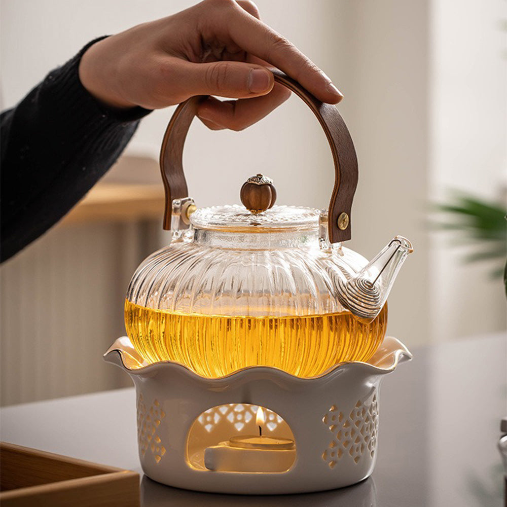 Elegant Pumpkin Glass Tea Set displayed on a wooden tea tray, showcasing the ceramic heater and teapot.