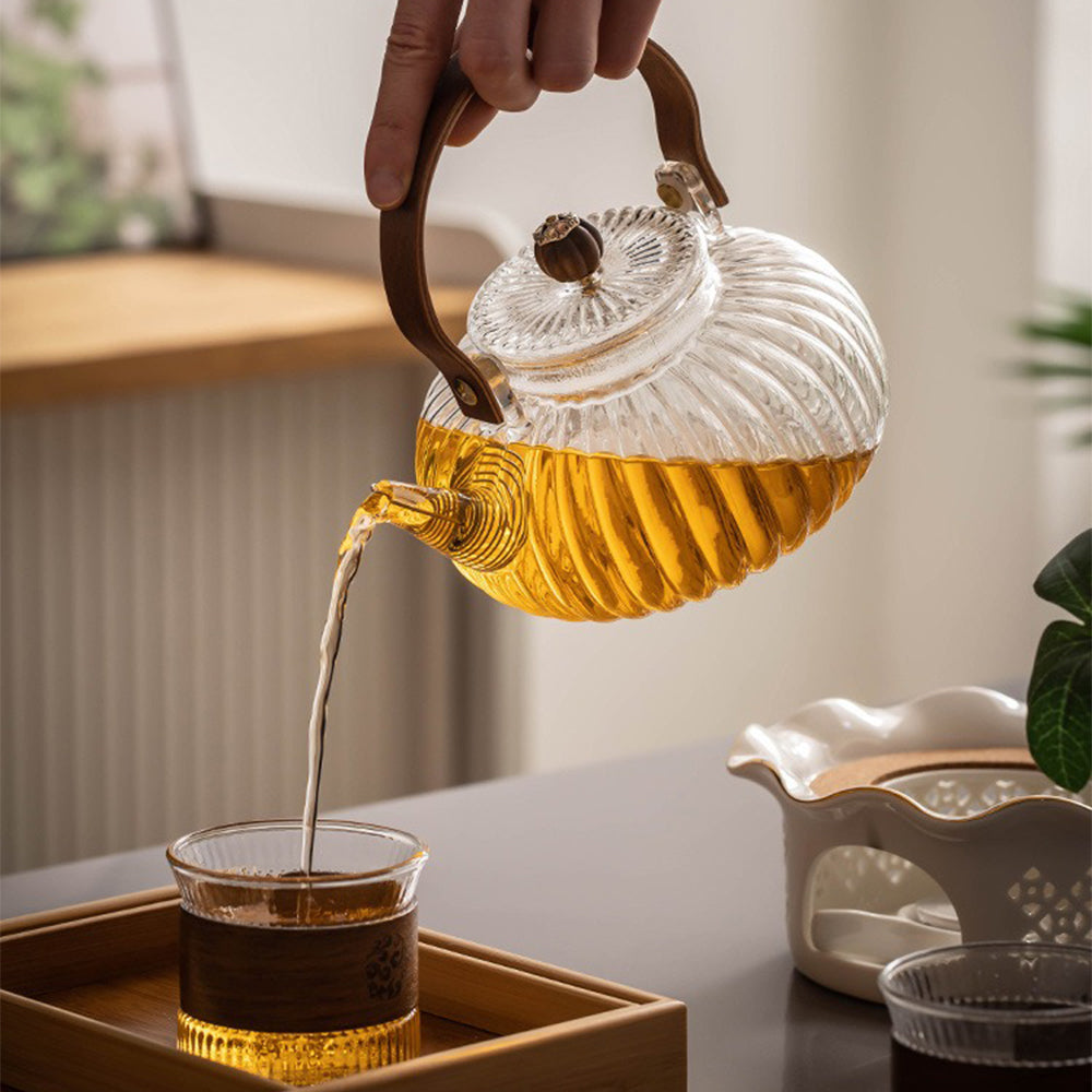 Close-up of the intricate pumpkin stripe design on the glass teapot and cups.