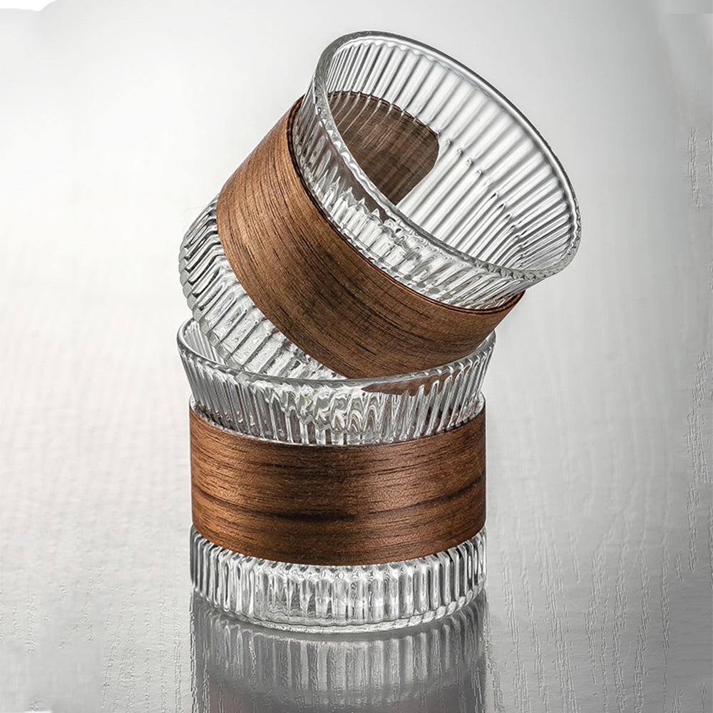 Top-down view of the glass gongfu tea set arranged on the wooden tray, highlighting the induction heater and elegant cup design.