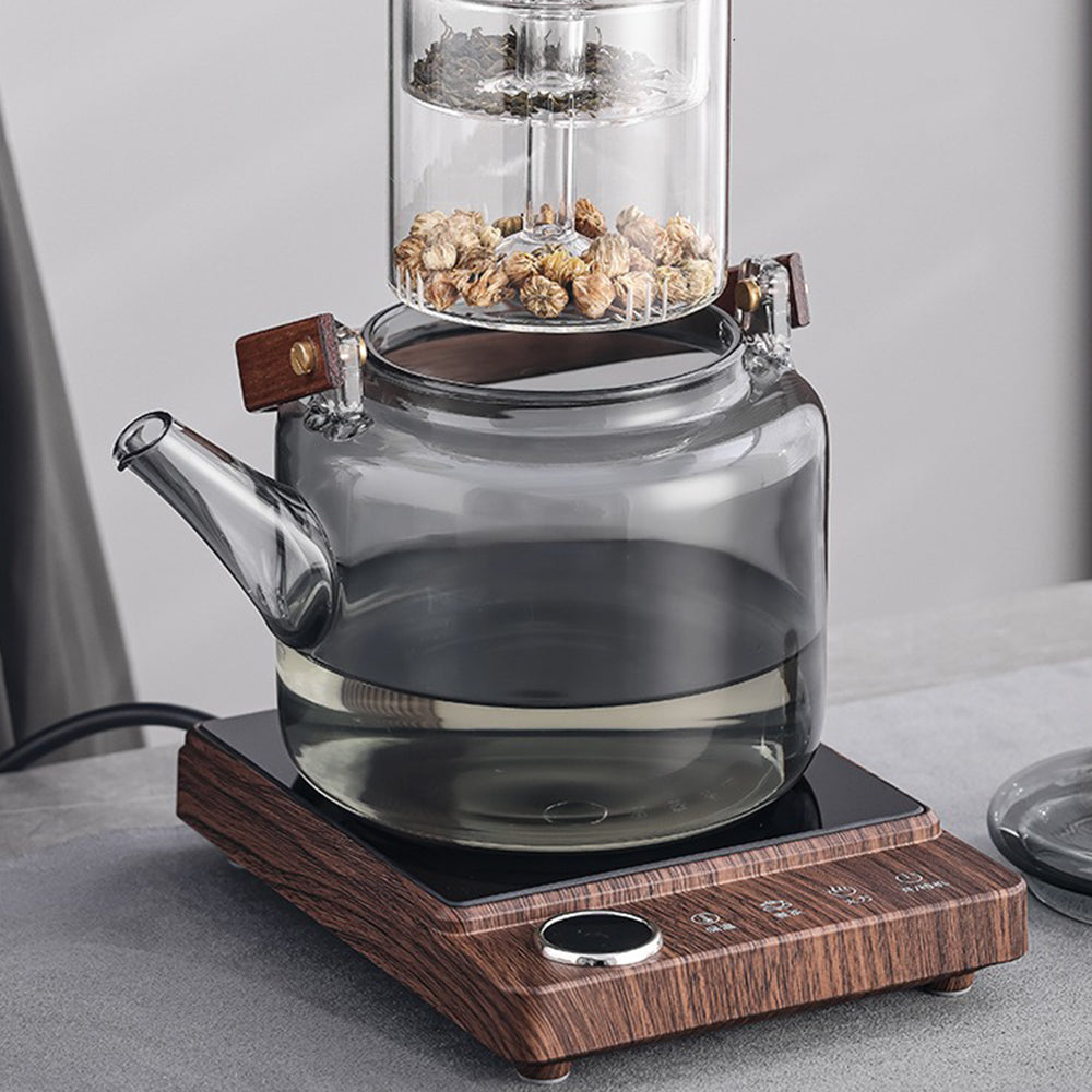 Close-up of the high-quality glass teapot with induction warmer, showcasing its sleek design and heat-resistant glass.