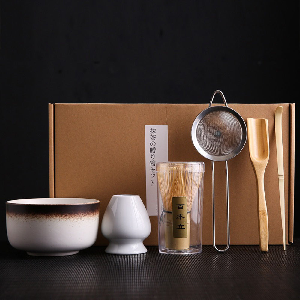 Artisan matcha tea set with bamboo whisk and ceramic bowl, perfect for frothy tea preparation.