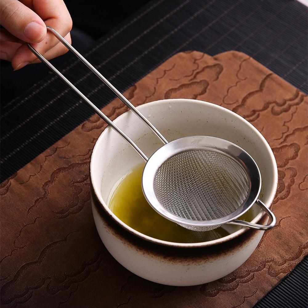 Artisan matcha tea set with bamboo whisk and ceramic bowl, perfect for frothy tea preparation.