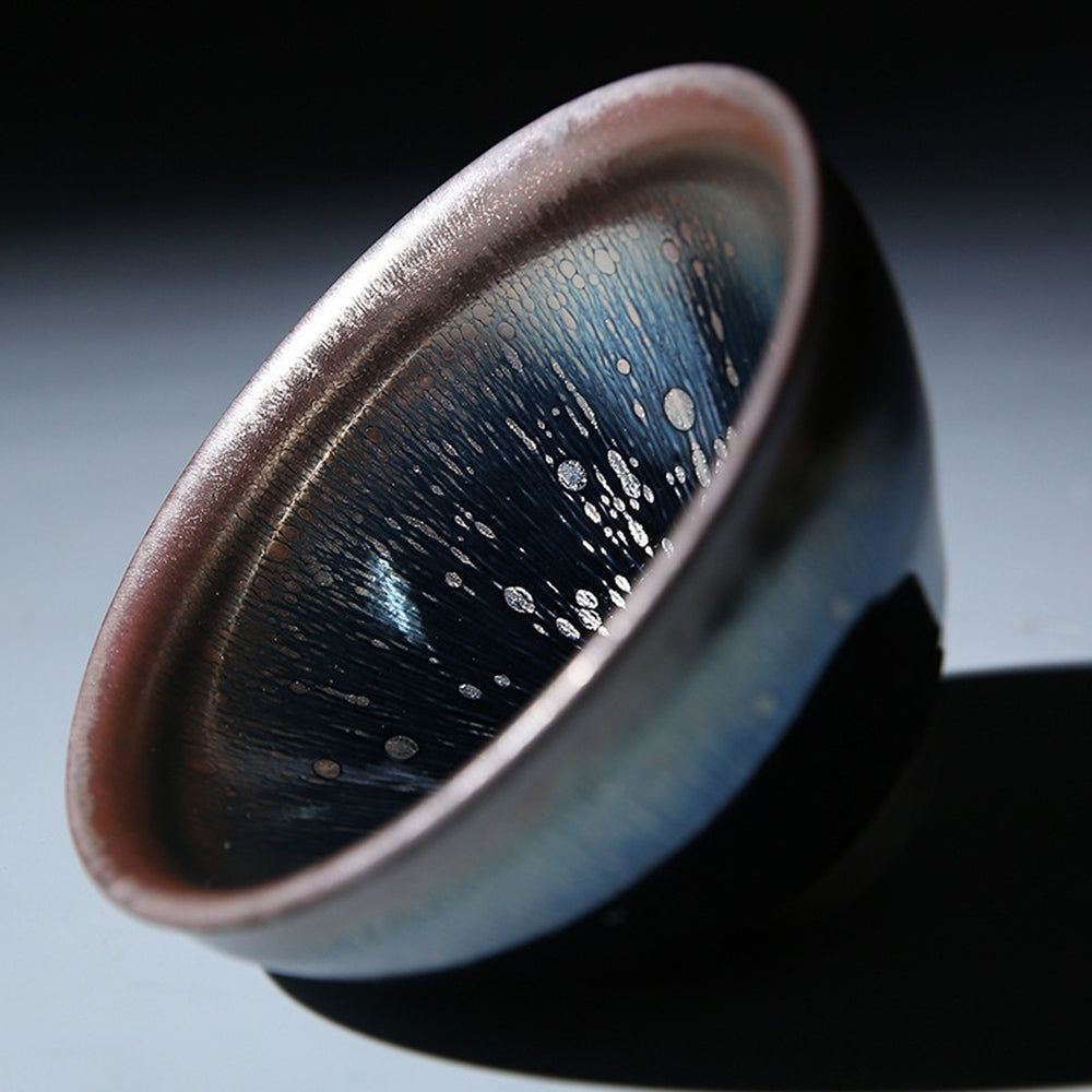 Close-up of handcrafted ceramic matcha bowl with textured gradient pattern
