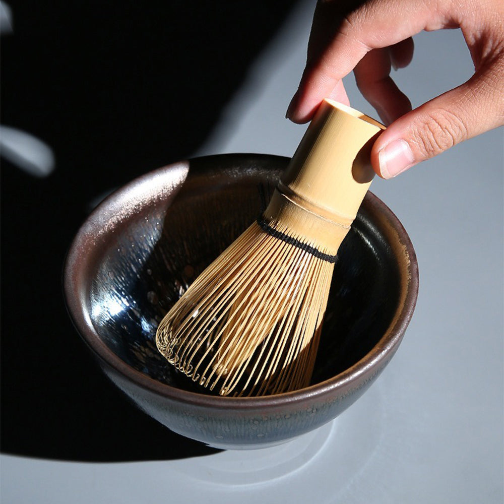 Elegant Japanese matcha bowl with tea whisk and cup, ready for preparation
