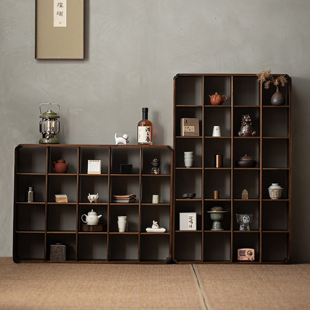 Multi-compartment wooden display shelf organized with decorative items and books.