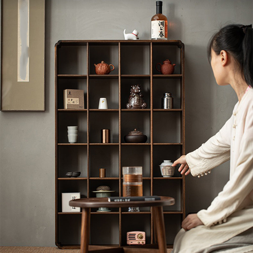 Multi-compartment wooden display shelf organized with decorative items and books.