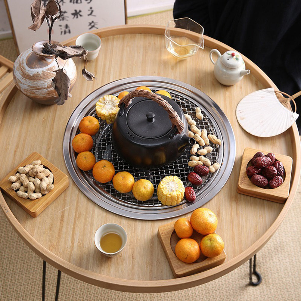 Close-up of the stove and grill integrated into the wooden tea table