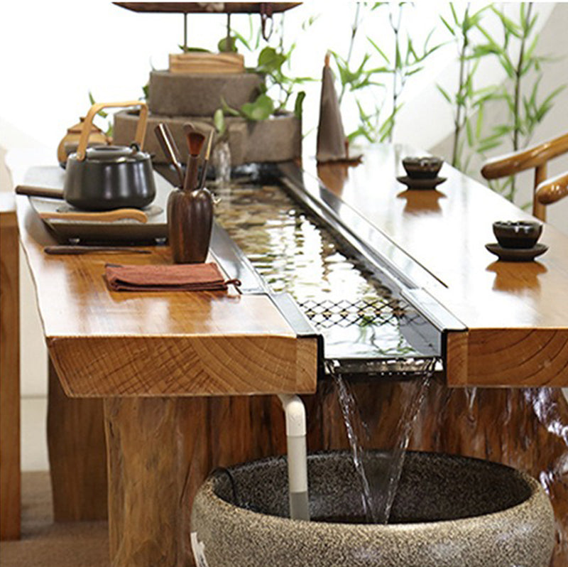 Elegant Chinese furniture with a flowing water tea table in a traditional setting