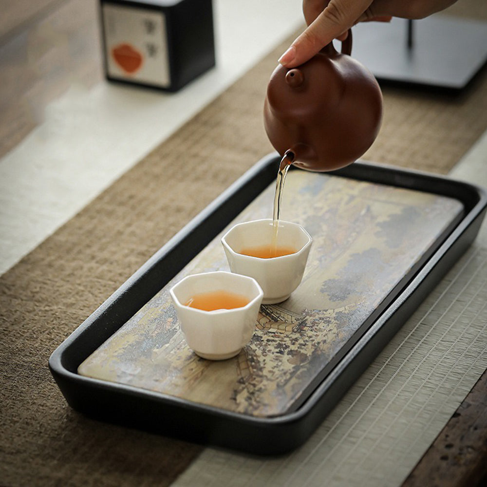 Top view of Qingming ceramic tea tray showing ink-style pattern and water-absorbing surface