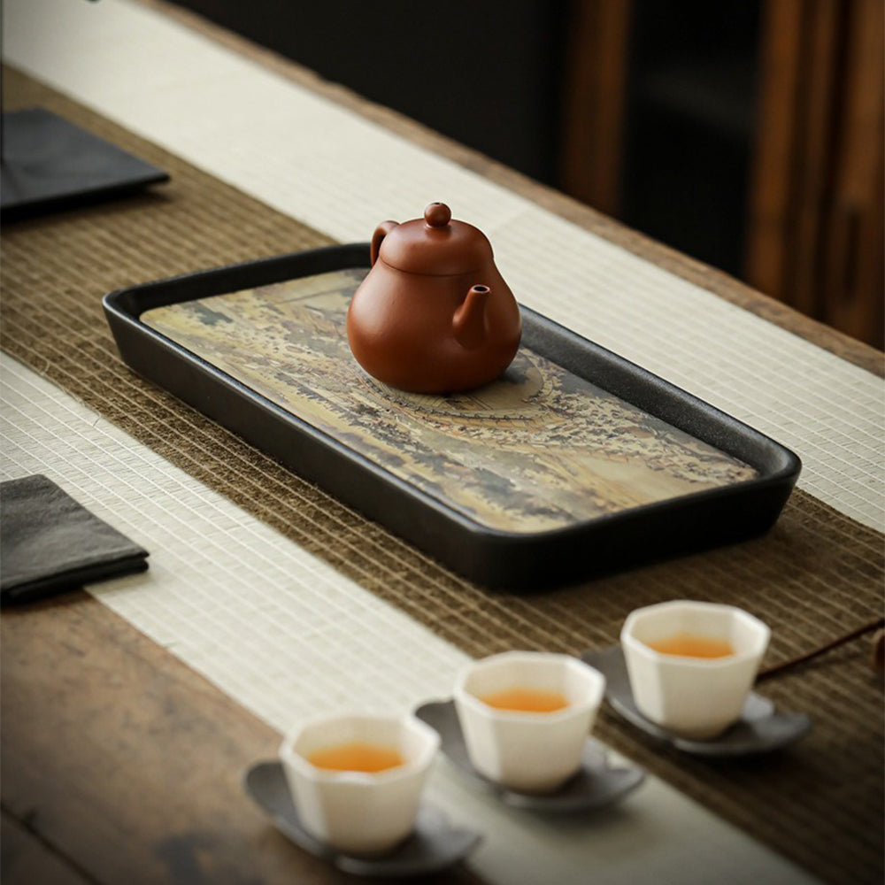 Side angle of ceramic tray highlighting raised edges and black base for stability
