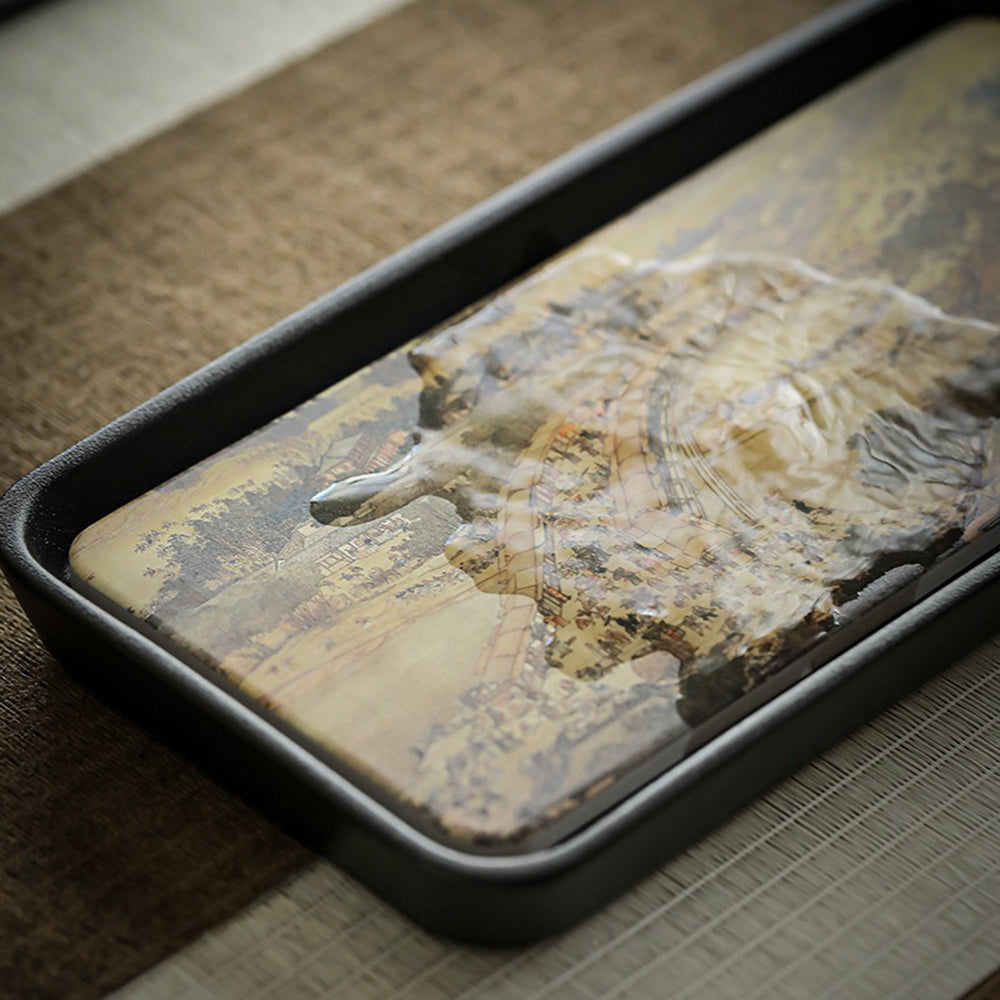 Side angle of ceramic tray highlighting raised edges and black base for stability