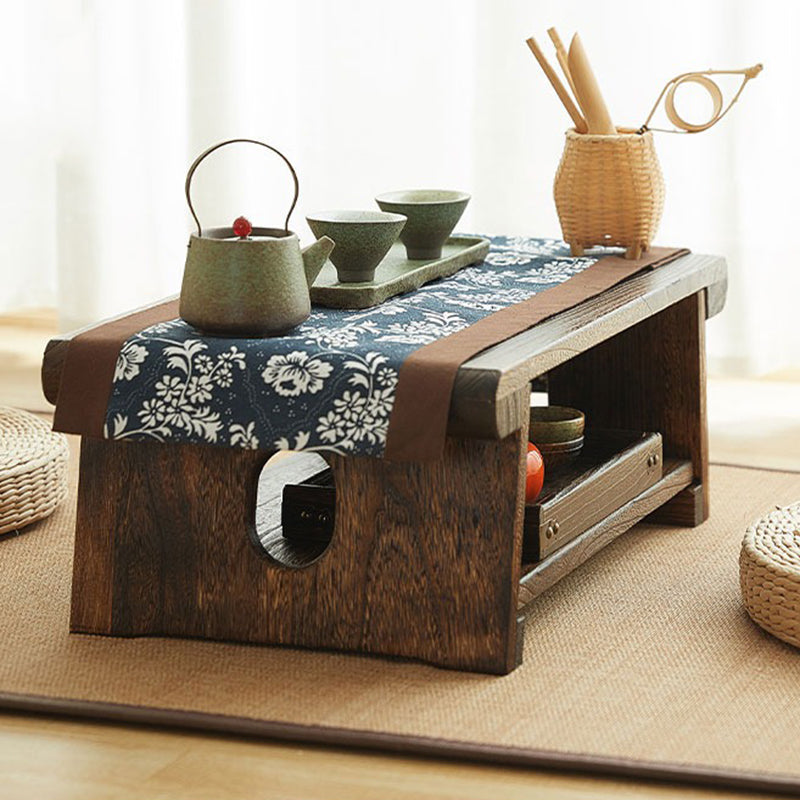 Side angle of the foldable tea table in a minimalist living room setup, highlighting its compact design.
