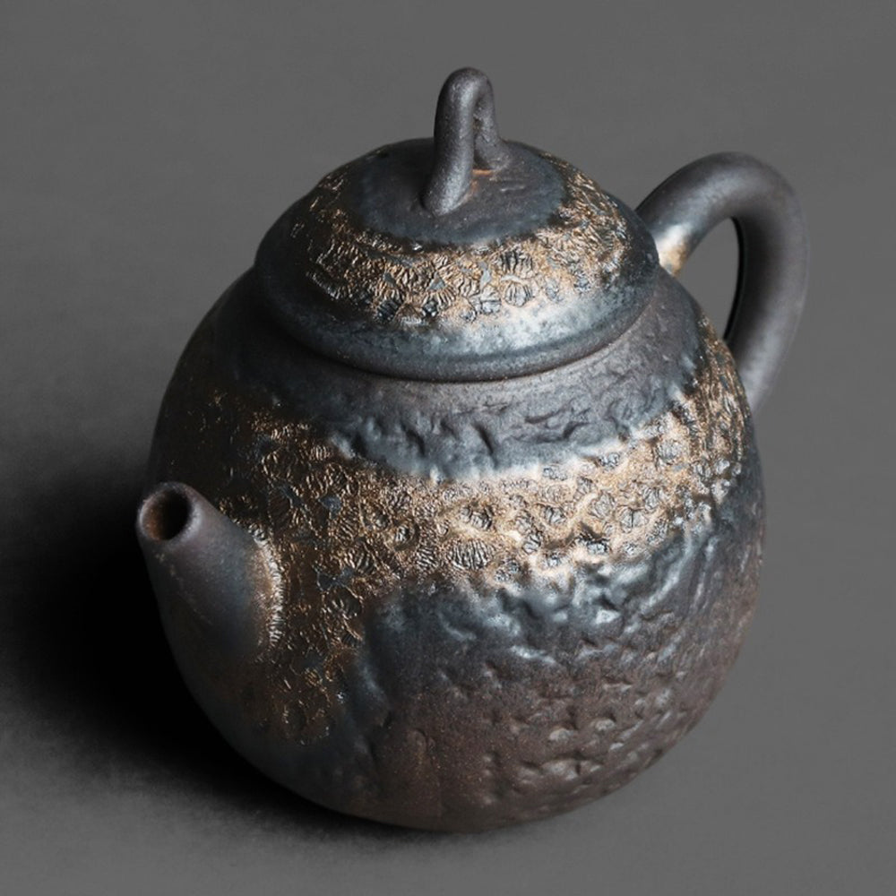 Top-down angle of the teapot highlighting the secure lid and built-in spherical tea filter