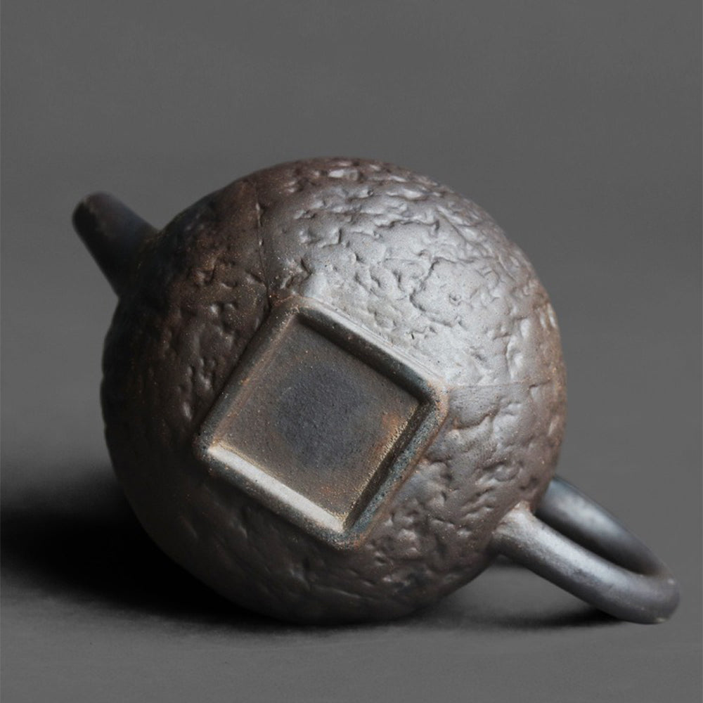 Top-down angle of the teapot highlighting the secure lid and built-in spherical tea filter