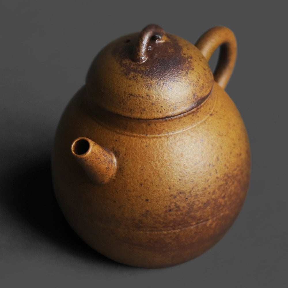Close-up of the stoneware teapots textured surface and elegant shape