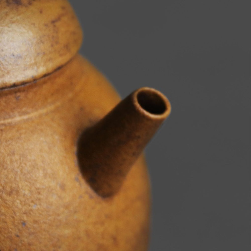 Close-up of the stoneware teapots textured surface and elegant shape