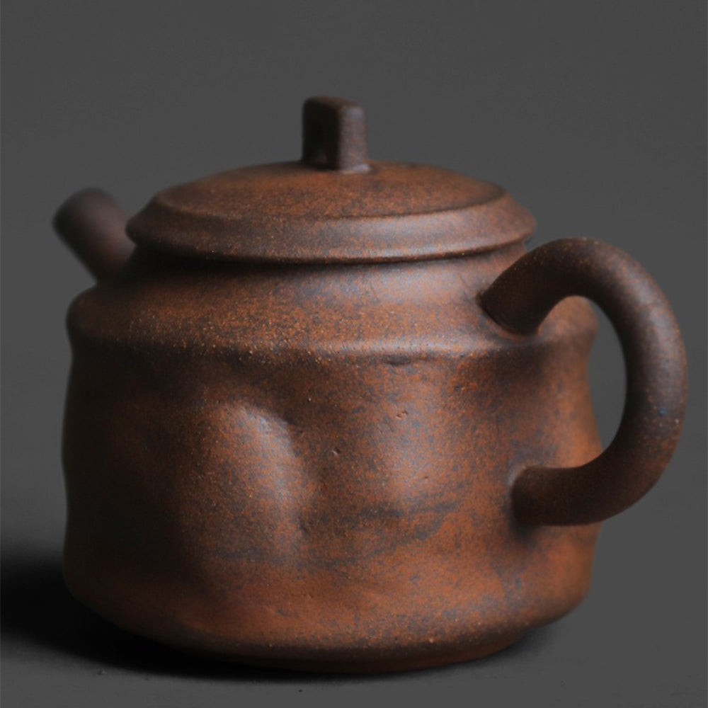 Close-up of old rock clay teapot showing granular texture and rustic finish