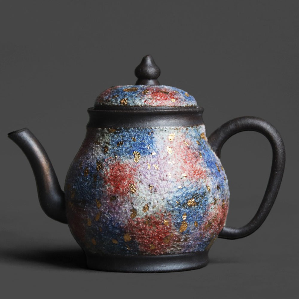 Top view of the Junde sandstone teapot showing turquoise and red agate accents