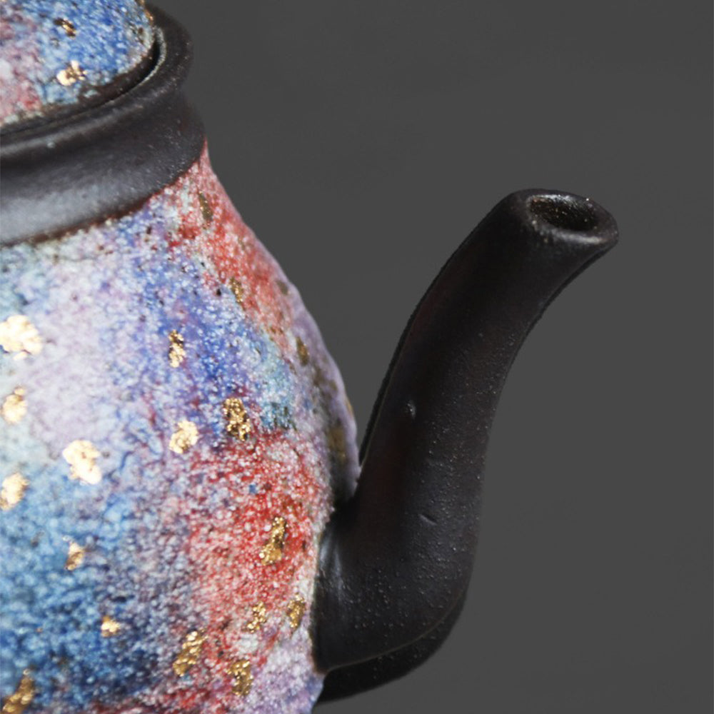 Top view of the Junde sandstone teapot showing turquoise and red agate accents