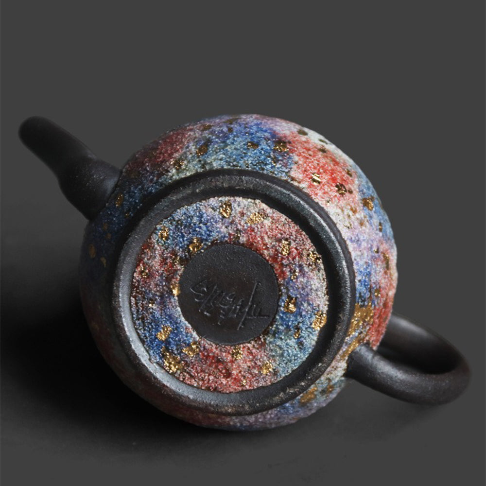 Side angle of the Chinese teapot highlighting its mineral texture and ergonomic handle