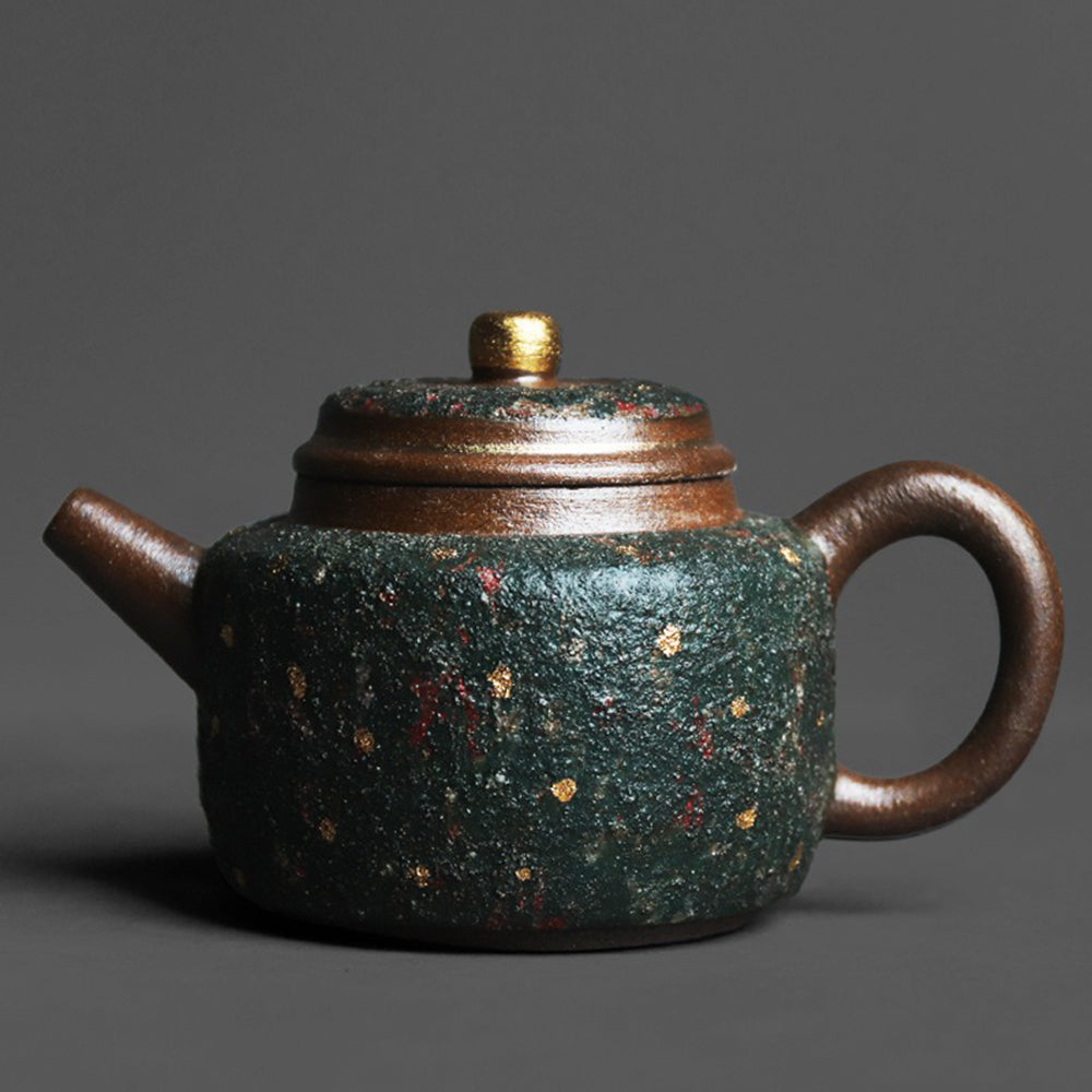 Close-up of green sandstone teapot with gold speckles showing natural texture