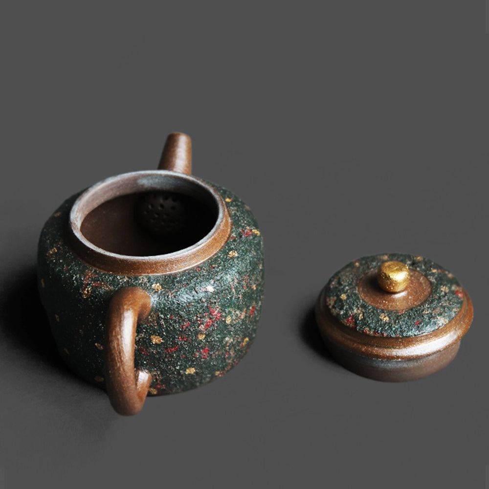 Close-up of green sandstone teapot with gold speckles showing natural texture