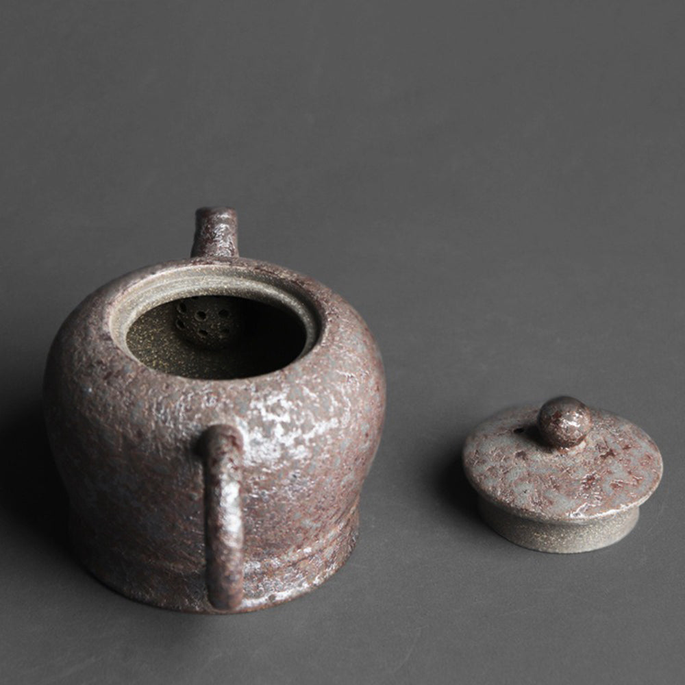 Close-up of rust spots on traditional wood-fired teapot showing craftsmanship