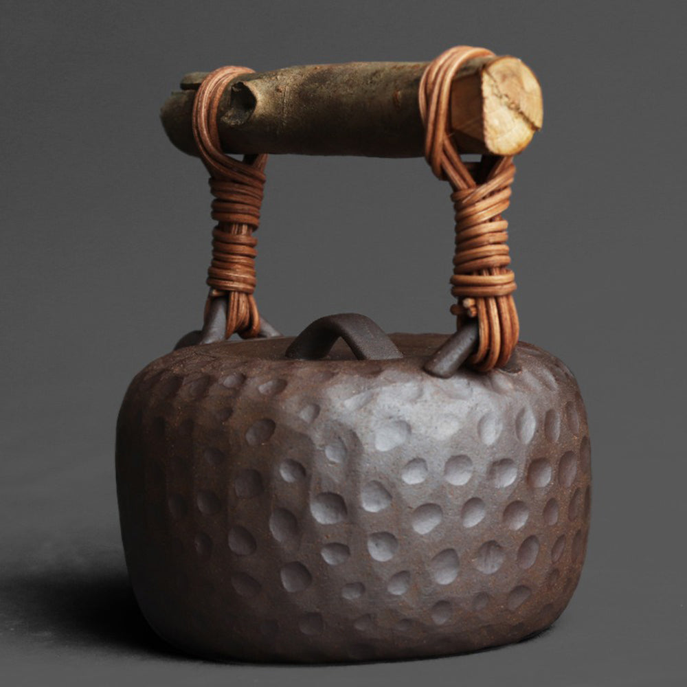Elegant Japanese hammered pottery teapot in a cozy tea setting