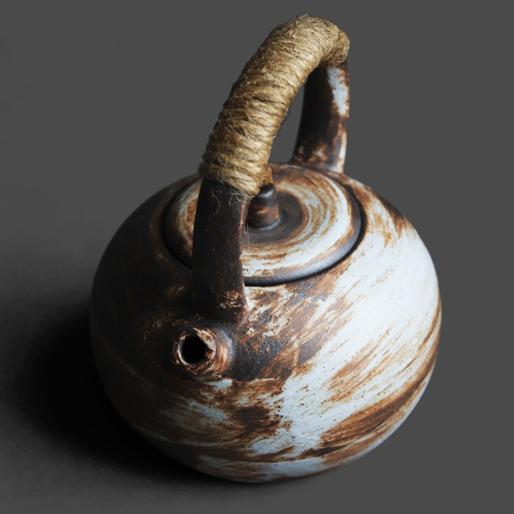 Wabi-Sabi Japanese teapot displayed over an open flame, demonstrating its versatility for brewing loose leaf tea.