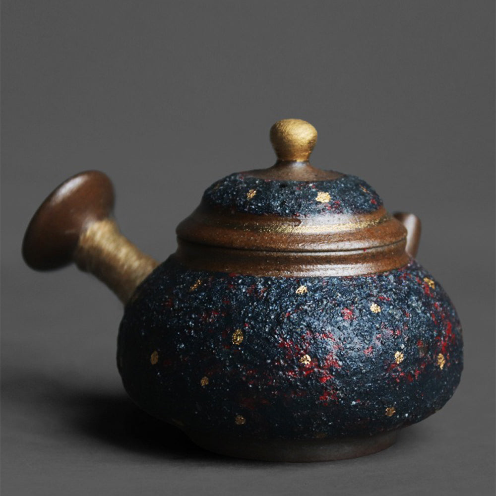 Side view of the teapot highlighting the hemp rope handle and the elegant lid with a golden knob.