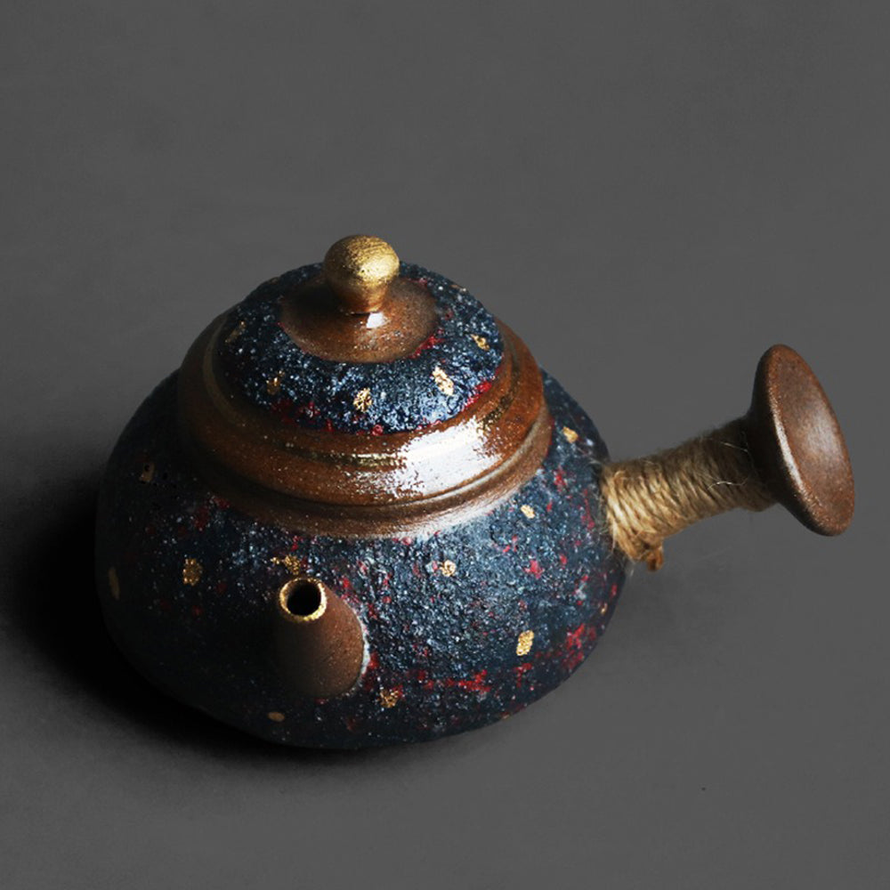 Full view of the teapot filled with steaming tea, emphasizing its unique design against a rustic backdrop.