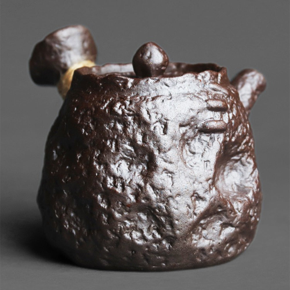 Interior view of a clay teapot with spherical filter designed for loose leaf tea