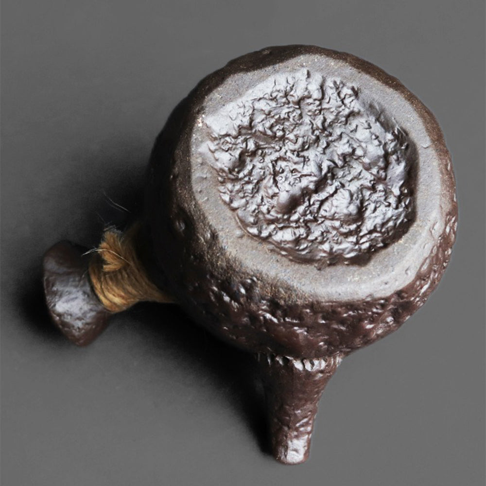 Interior view of a clay teapot with spherical filter designed for loose leaf tea