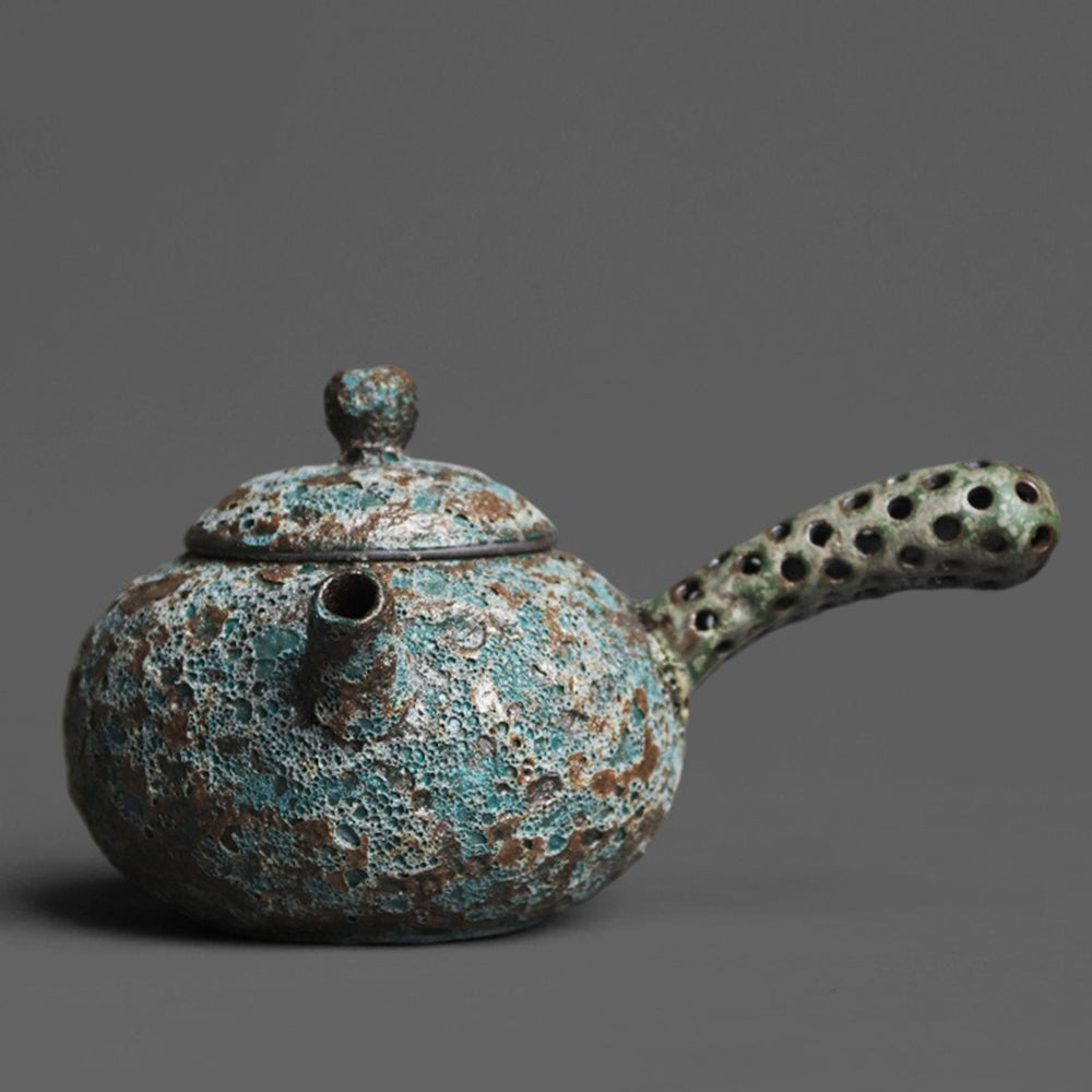 Wormhole Bronze Kyusu Teapot from a side angle highlighting its unique handle design.