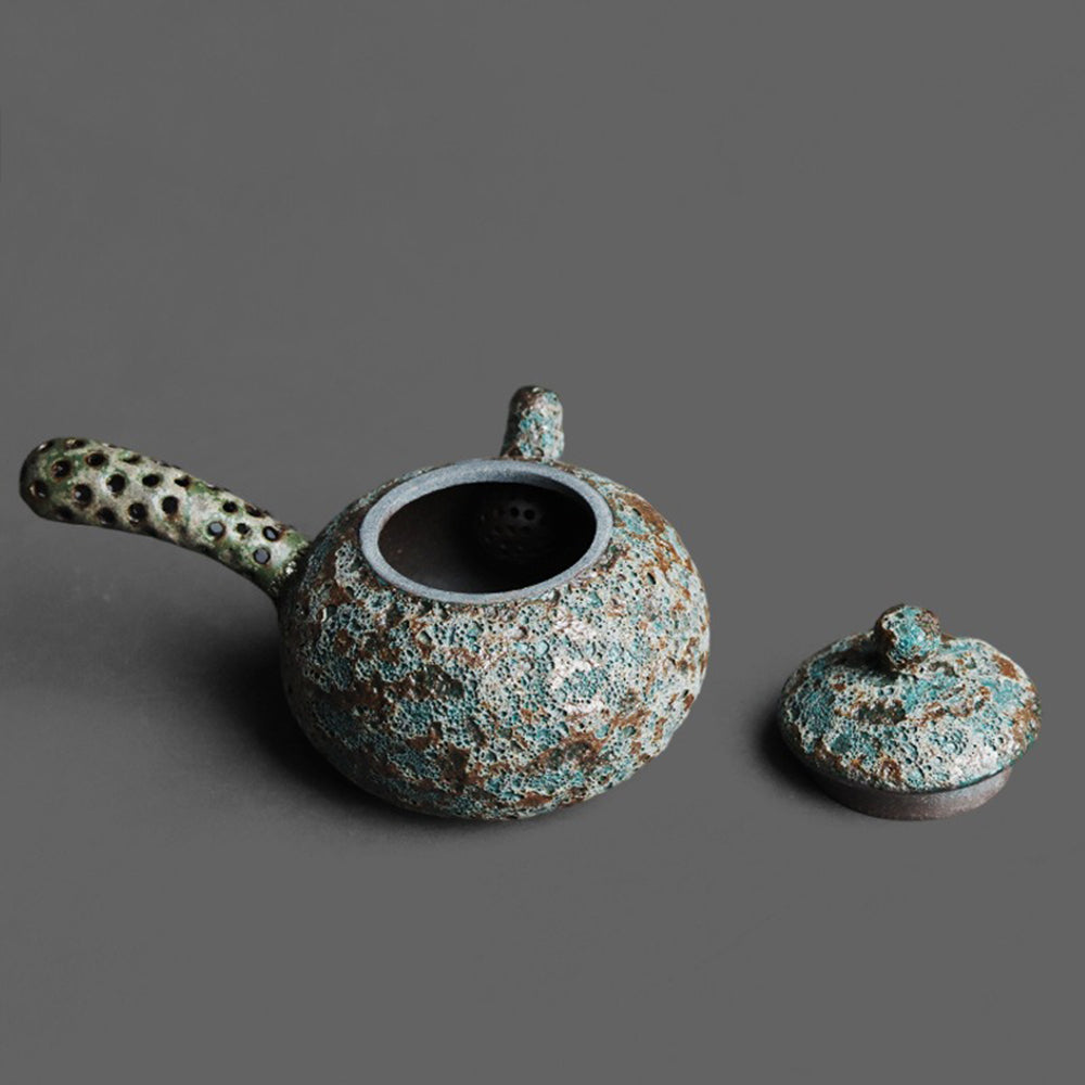 Wormhole Bronze Kyusu Teapot from a side angle highlighting its unique handle design.