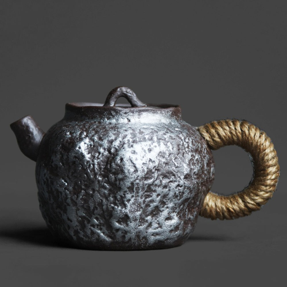 Top view of the Japanese teapot showing silver detailing and stone texture