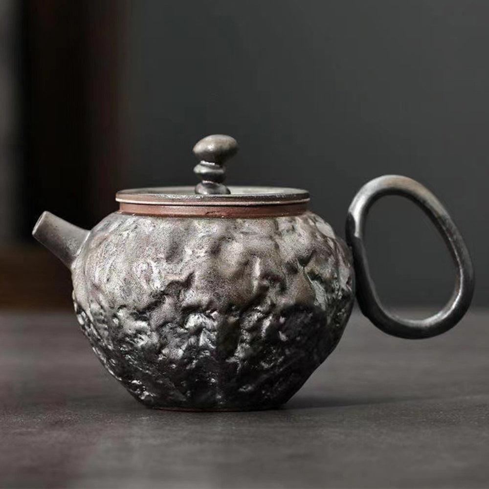 Artistic rust-glazed Japanese teapot showcasing unique kiln-varied design.
