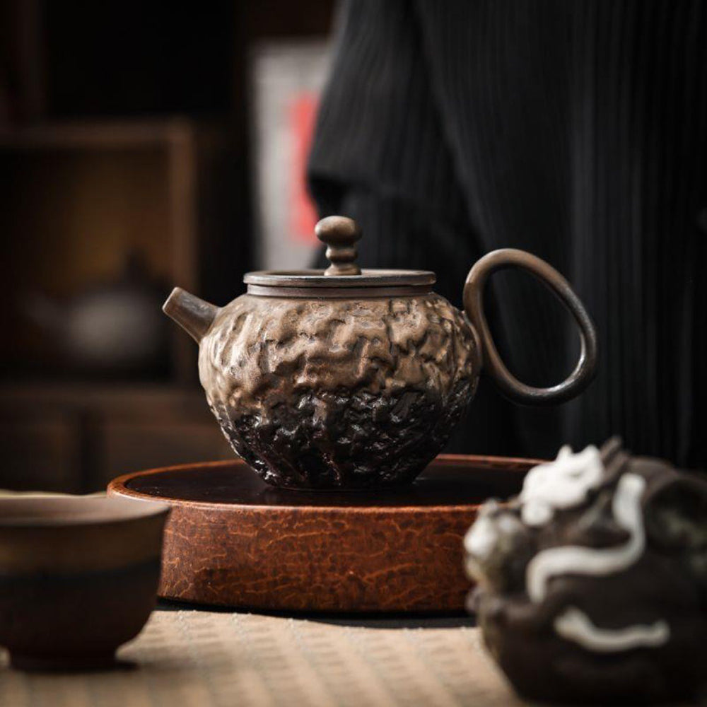 Close-up of a handcrafted Japanese teapot highlighting its luxurious details.