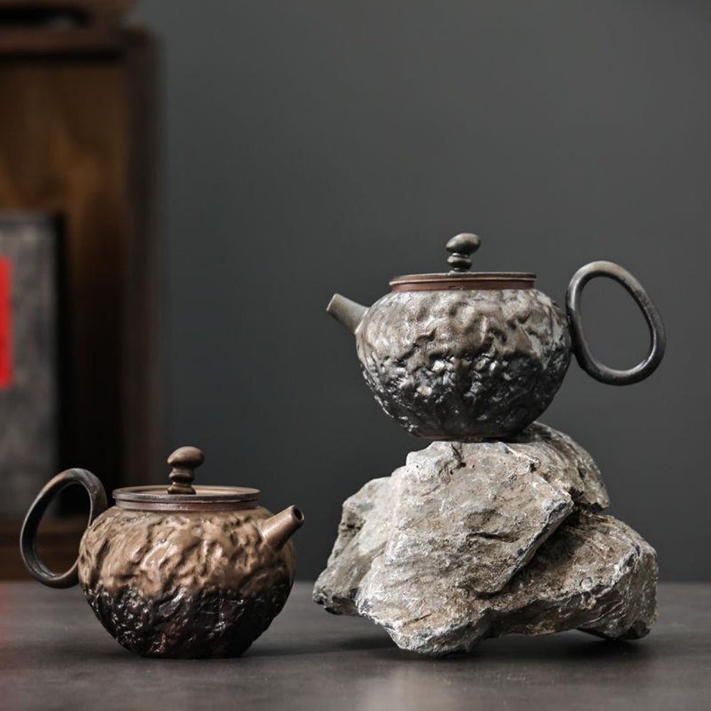 Artistic rust-glazed Japanese teapot showcasing unique kiln-varied design.