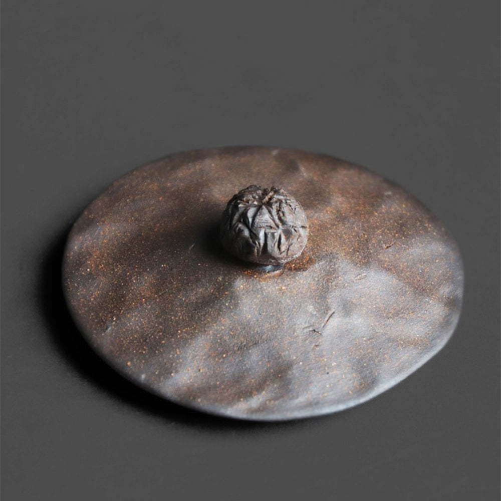 Side angle of vintage coarse pottery cup with traditional craftsmanship details