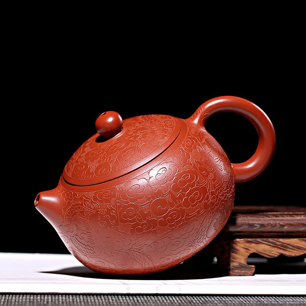 Elegant Yixing teapot with auspicious cloud patterns, perfect for tea ceremonies.